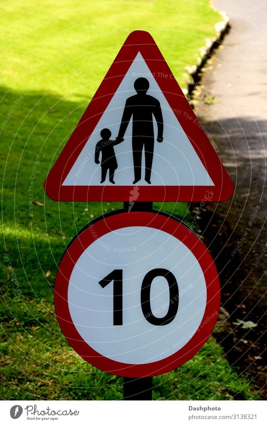 Speed and Children Crossing Road Sign on a Country Road Parenting Toddler Father Adults Grass Leaf Transport Motoring Street Lanes & trails Signage Warning sign