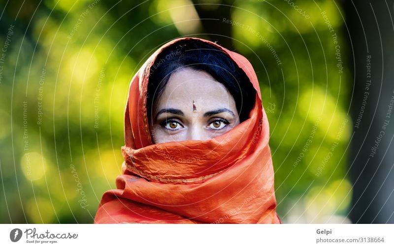 Beautiful girl with a orange scarf in a park Lifestyle Face Illness Human being Woman Adults Culture Fashion Clothing Scarf Headscarf Brunette Concern Stress