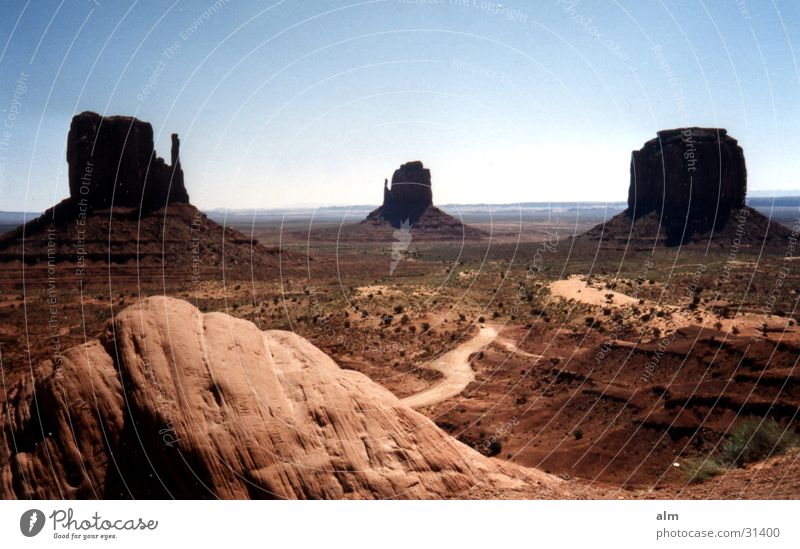 the rock Blue sky Desert Rock Rock formation Monument Valley Famousness Attraction Tourist Attraction Clear sky Cloudless sky Around-the-world trip Destination