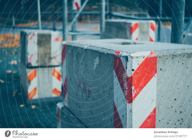 Concrete blocks on scaffolding Small Town Outskirts Hideous Construction site Signs and labeling Exterior shot Warn Stripe Red Gray Scaffolding Heavy Street
