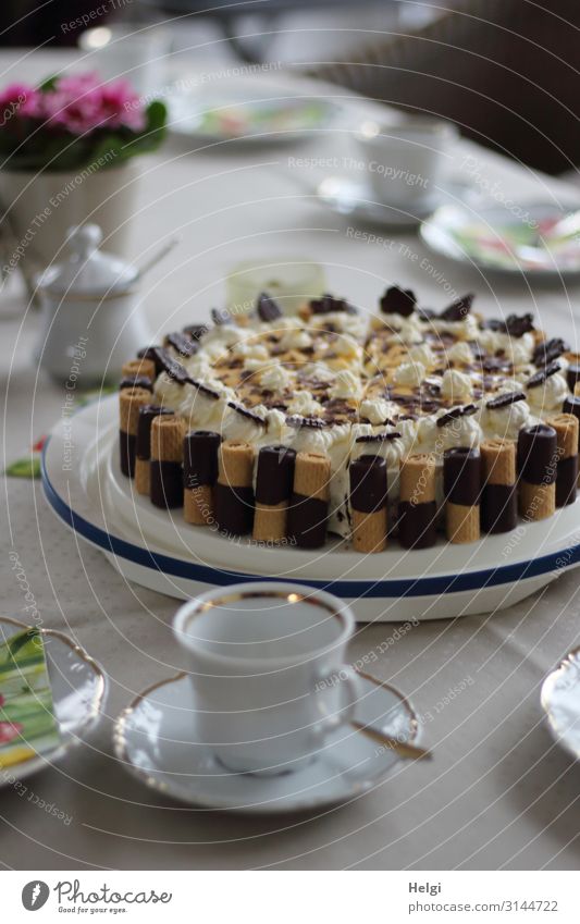decoratively decorated cake on a laid coffee table with dishes and flowers Food Cake Nutrition To have a coffee Crockery Plate Cup Spoon Feasts & Celebrations