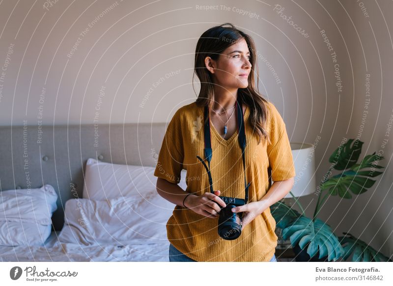 photographer woman at home holding a camera. Technology and lifestyle indoors Caucasian Woman Youth (Young adults) Photographer Camera reflex Home Lifestyle