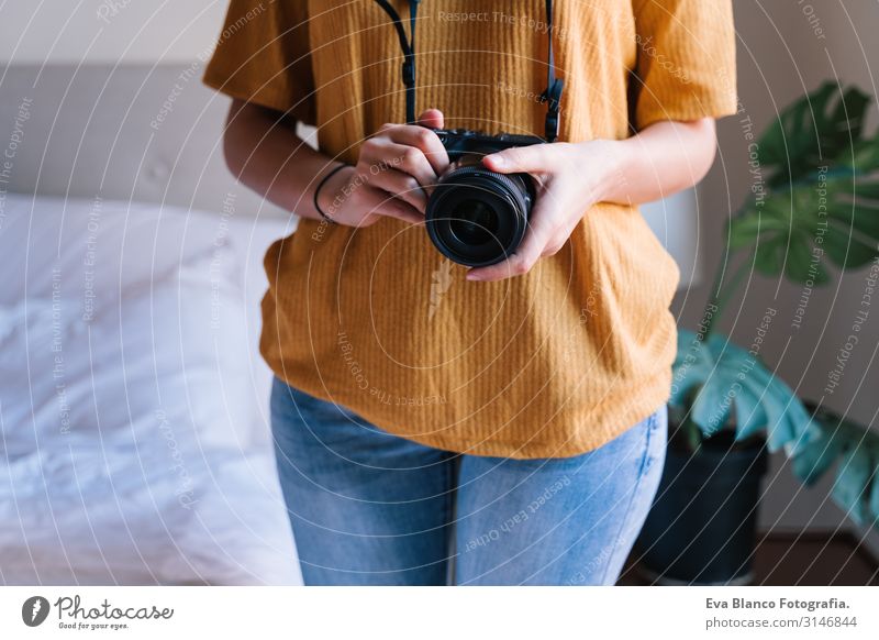 photographer woman at home holding a camera. Technology and lifestyle indoors Caucasian Woman Youth (Young adults) Photographer Camera reflex Home Lifestyle