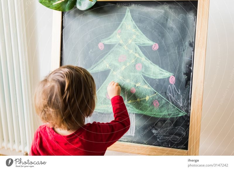 A child painting christmas tree on blackboard Lifestyle Joy Beautiful Winter Winter vacation Feasts & Celebrations Christmas & Advent Child Blackboard