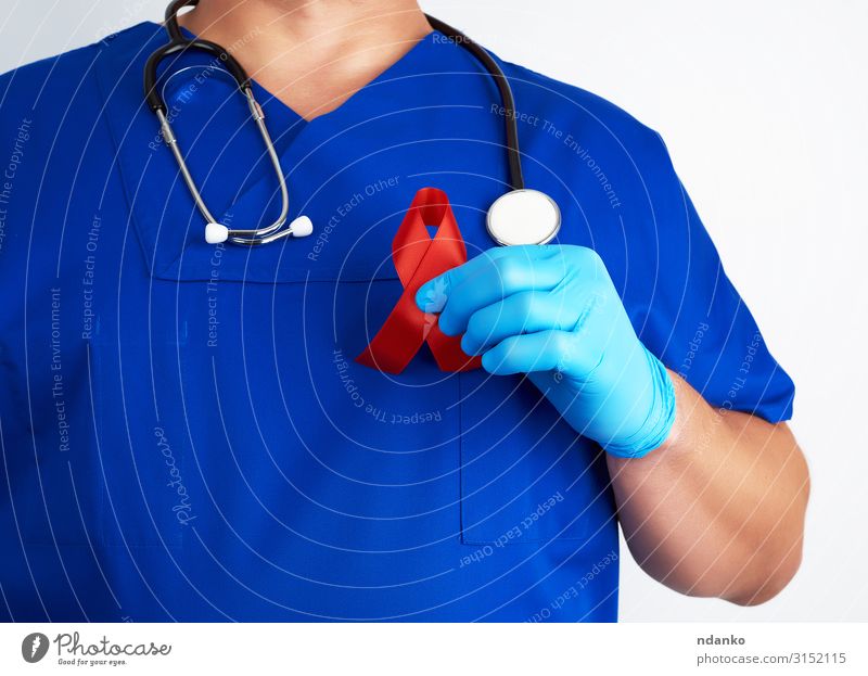 doctor holds a red ribbon Healthy Health care Medical treatment Illness Medication Doctor Human being Man Adults Hand Fingers Landmark String Red White Hope