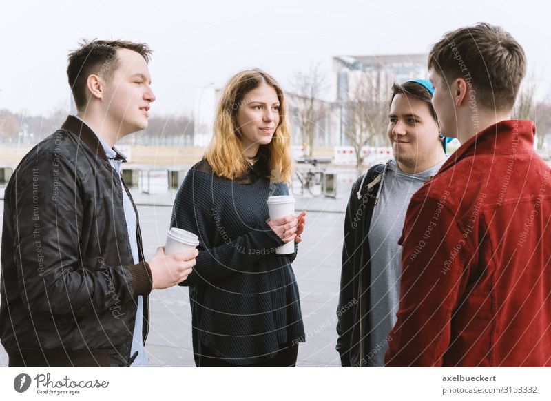 4 teenagers talking in the street Hot drink Coffee Latte macchiato Mug Lifestyle Joy Leisure and hobbies University & College student Human being Young woman