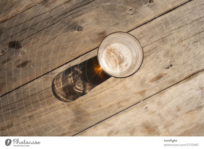 closing time Beverage Beer Glass Drinking Wooden table Break To enjoy Evening sun Closing time Calm Exterior shot Copy Space bottom Light Shadow Contrast