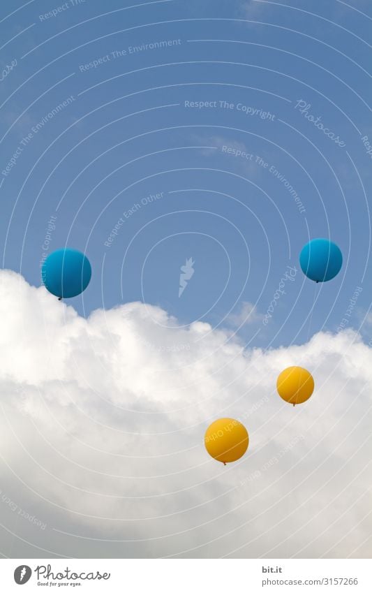 Four balloons in yellow and blue on a string, flying up into the air at a festival outside, into the blue sky with clouds l 1600 Freedom Party Event