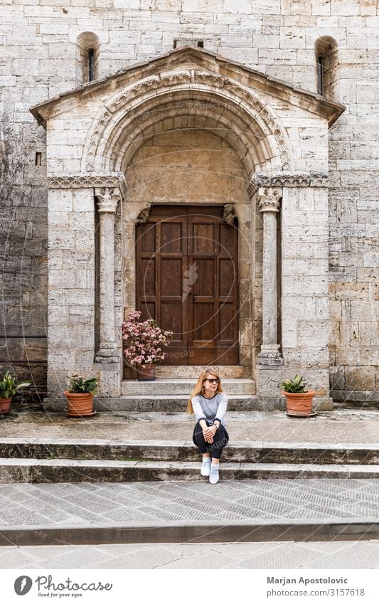 Young woman traveler sitting on the steps of an old church Lifestyle Vacation & Travel Tourism Trip Sightseeing Feminine Youth (Young adults) Woman Adults 1