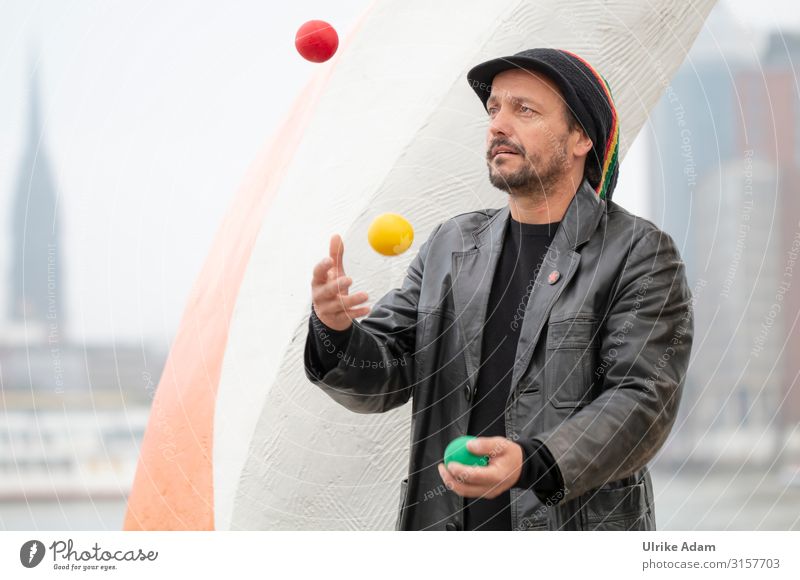 Juggler on the banks of the Elbe Artist Human being Masculine Man Adults 1 45 - 60 years Jacket Leather Cap Facial hair Ball juggling balls Throw Athletic