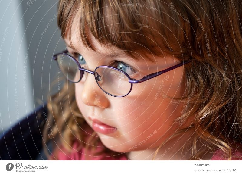 Young Blue Eyed Girl With Eye Glasses Looking Into The Light A