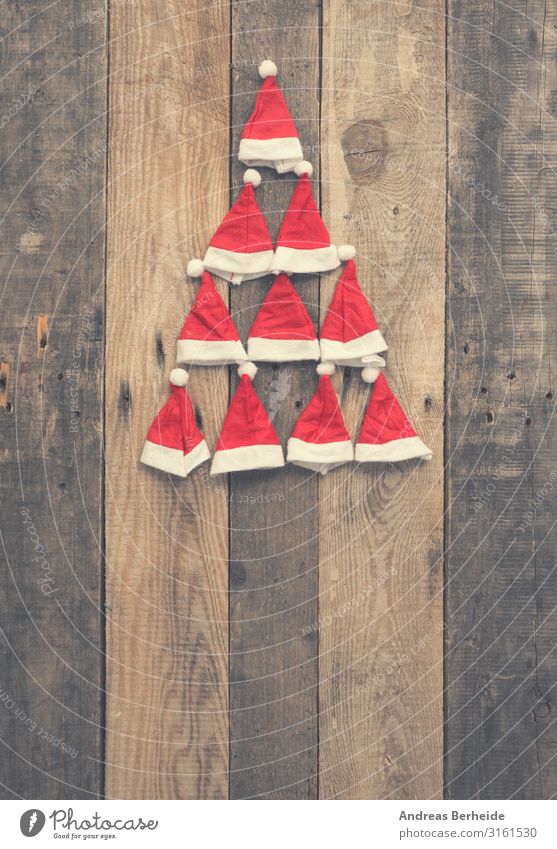 Christmas tree shape made with hats of Santa Style Winter Christmas & Advent Hat Cap Wood Ornament Tradition Santa Claus red rustic plank wooden nobody