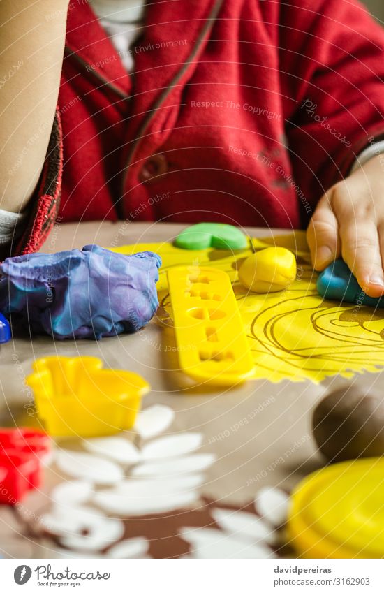 Closeup of plasticine molds and child hands on the background Dough Baked goods Joy Playing Table Child Boy (child) Infancy Toys Cute Creativity Action Clay
