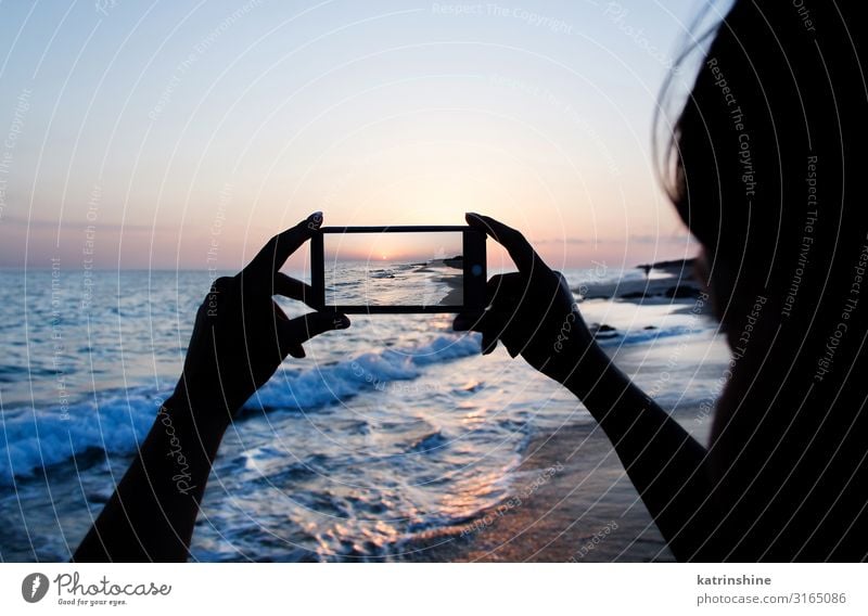 Girl is taking a sunset photo on the phone Vacation & Travel Summer Beach Ocean Cellphone PDA Technology Woman Adults Hand Environment Nature Landscape Sky Dark