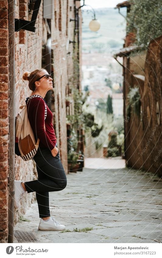 Young woman traveler in the streets of an old town Lifestyle Vacation & Travel Tourism Trip Adventure Sightseeing Human being Feminine Youth (Young adults)