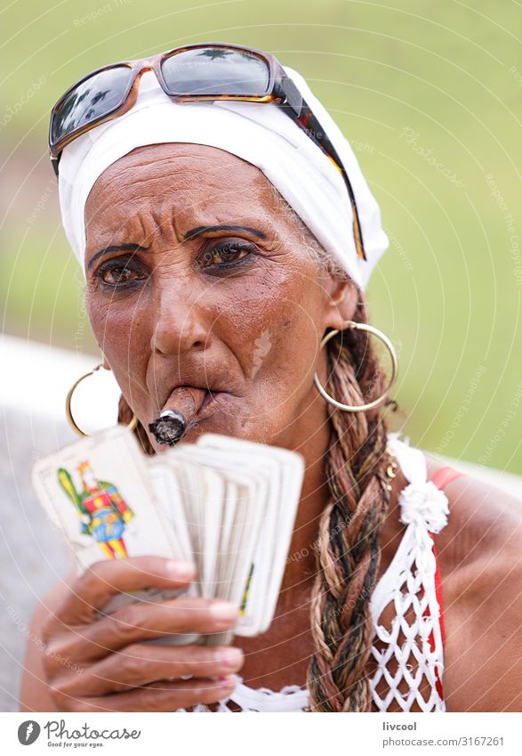 cuban woman smoking a cigar in a park in havana , cuba Feminine Female senior Woman Head Hair and hairstyles Face Eyes Nose Mouth Lips Hand 1 Human being