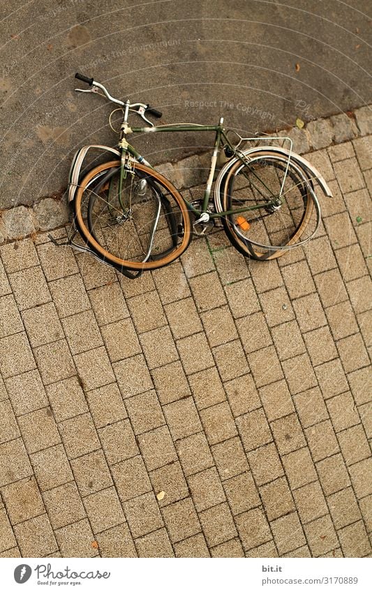 Old, broken bicycle lies on the sidewalk Transport Means of transport Traffic infrastructure Cycling Lie Broken Integrity Anger Aggravation Revenge Aggression