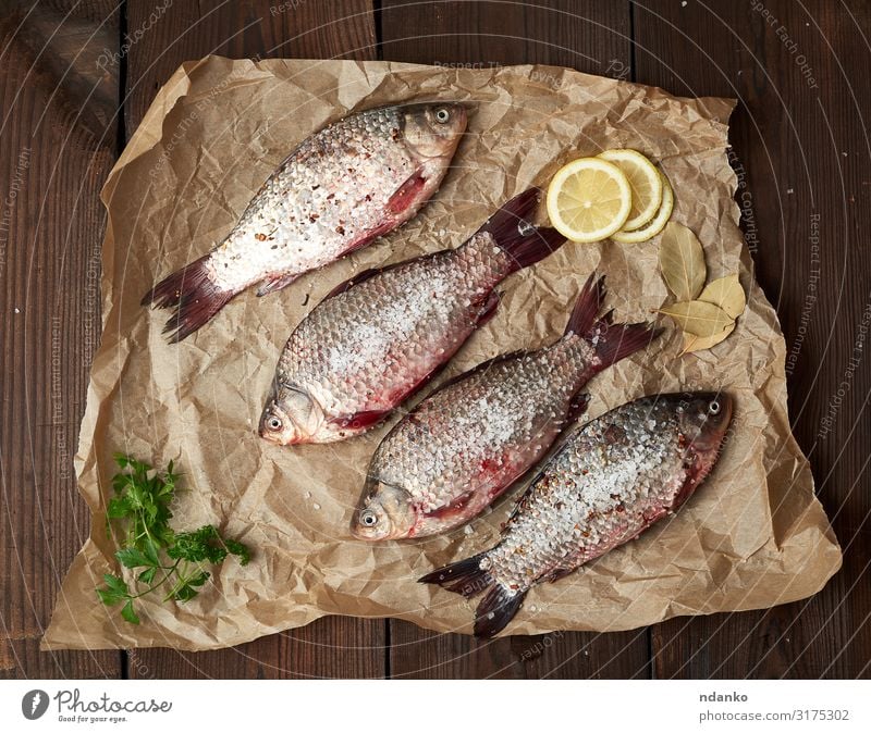 whole fresh crucian fish with scales Meat Fish Herbs and spices Nutrition Eating Dinner Diet Table Kitchen Animal River Paper Wood Fresh Delicious Natural Above