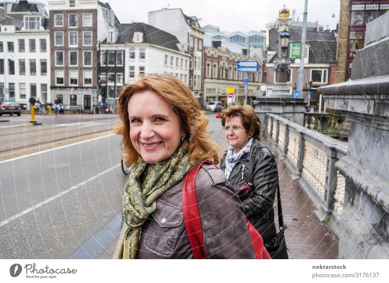 Two Middle Aged Women Standing on Bridge in Amsterdam Lifestyle Vacation & Travel Tourism Woman Adults Clouds Downtown Street Smiling White crossing real life