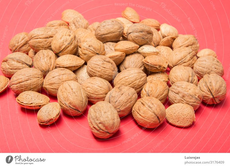 nuts and almonds on red background Food Nut Almond Picnic Organic produce Vegetarian diet Diet Design Autumn Warmth Brown Yellow Dried fruits health Consistency