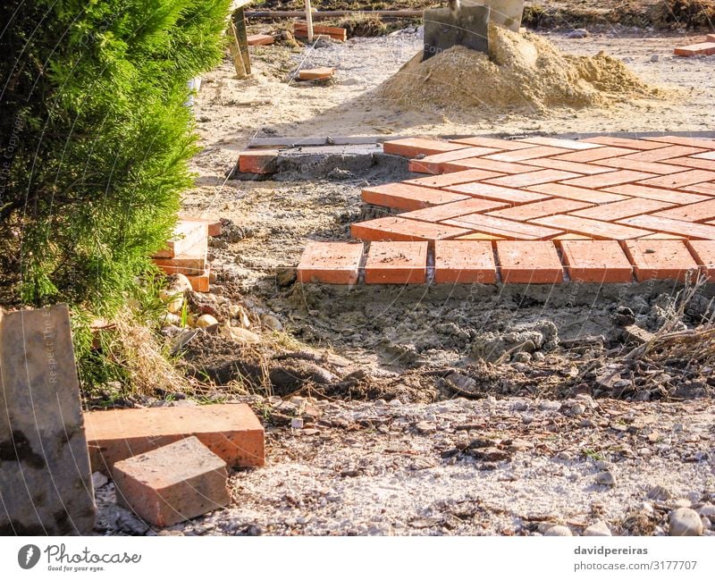 Orange brick paving stones in construction process Work and employment Profession Tool Sand Building Architecture Terrace Lanes & trails Stone Concrete Red Pave