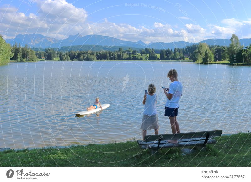 Family takes mobile phone photo at mountain lake Leisure and hobbies Vacation & Travel Tourism Trip Sports Fitness Sports Training Swimming & Bathing Girl