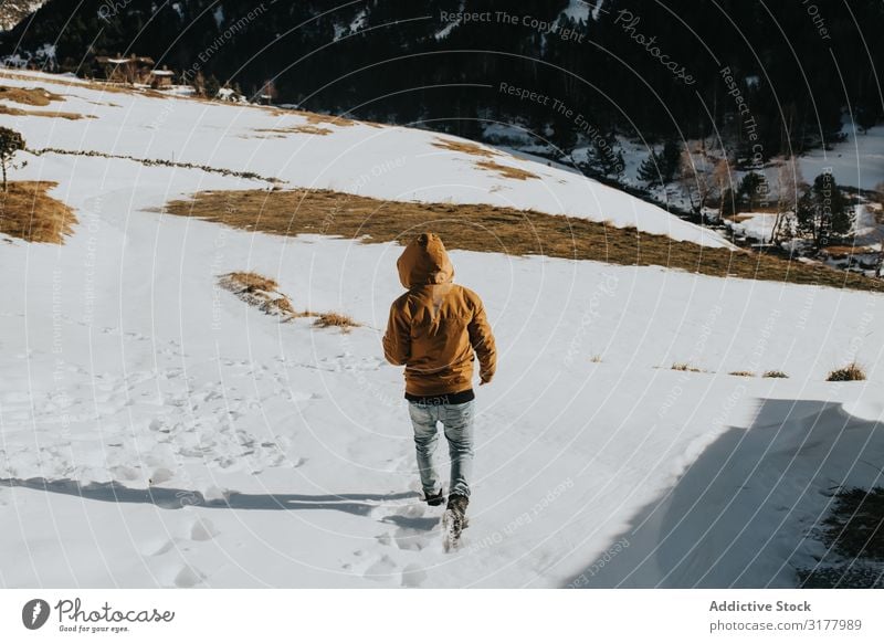 Man walking on footpath in snowy landscape Walking Car Hood Snow Footpath Mountain Landscape Slope Nature Action hiker Day Movement Winter Weather traveler