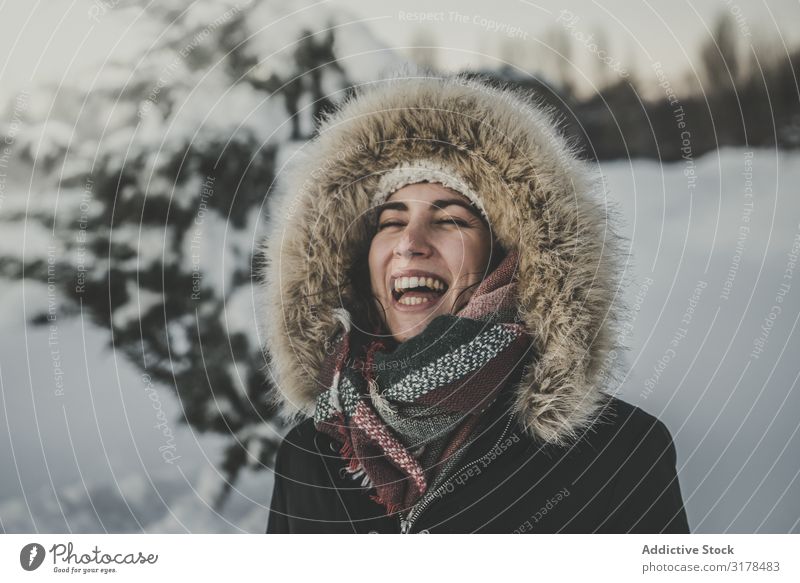 Young woman laughing on snowy background Woman Laughter Joy Snow Attractive Youth (Young adults) Warmth Clothing Fur coat Tree Conifer Winter Happy Happiness