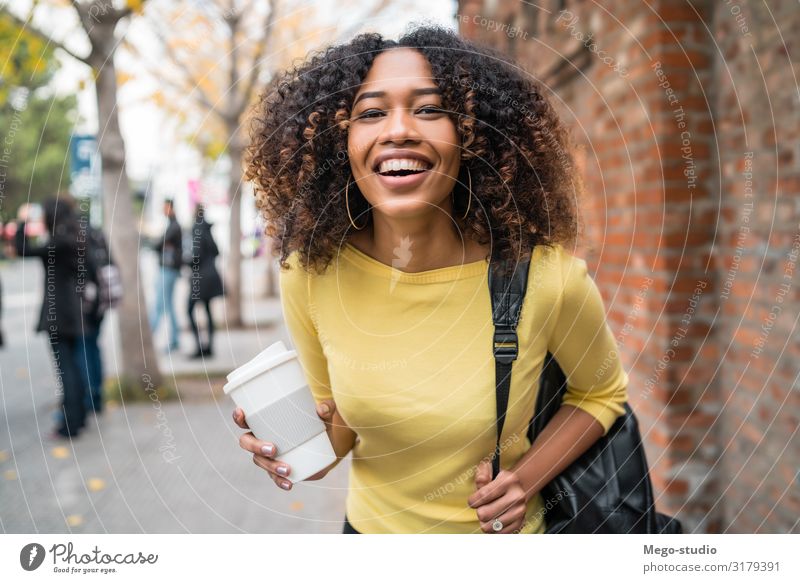Afro-american woman walking on the street. Drinking Coffee Lifestyle Style Happy Beautiful Academic studies Human being Woman Adults Town Street Fashion
