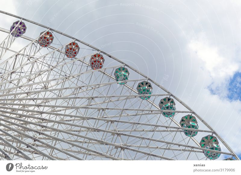 Detail of a still standing Ferris wheel with clouds Tourism City trip Summer Feasts & Celebrations Fairs & Carnivals Sky Clouds Manmade structures Rotate