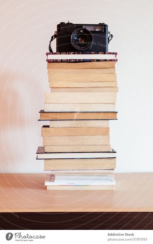 Vintage camera on top of a stack of books - a Royalty Free Stock Photo from  Photocase