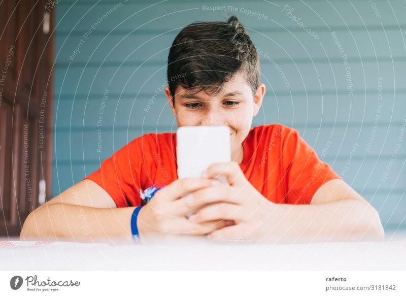 boy wearing red t-shirt sitting outdoors using phone Lifestyle Happy Leisure and hobbies Telephone Cellphone PDA Technology Human being Masculine Boy (child)