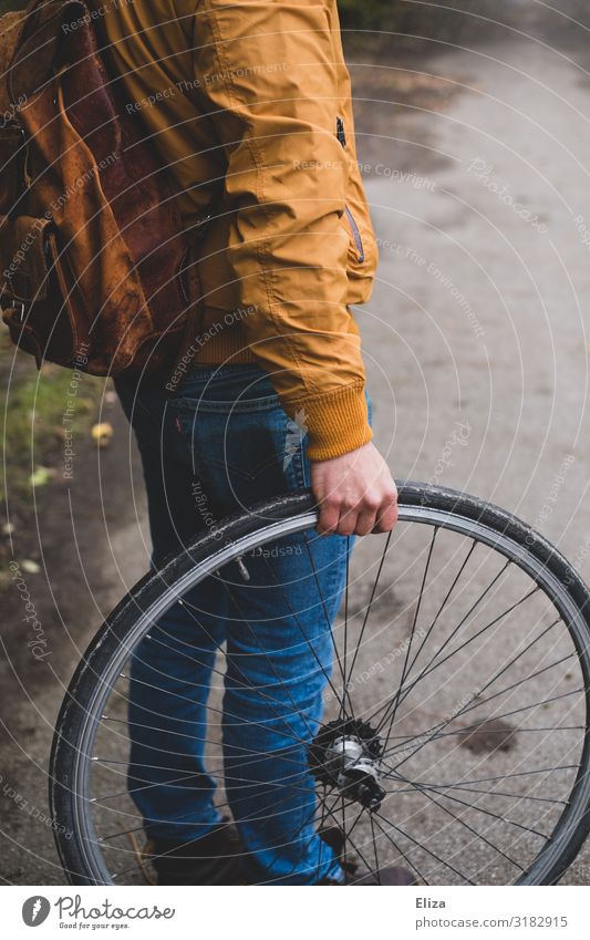 A man holding a bicycle tire Bicycle Human being Masculine Young man Youth (Young adults) Man Adults 1 18 - 30 years Environmental protection Wheel Tire