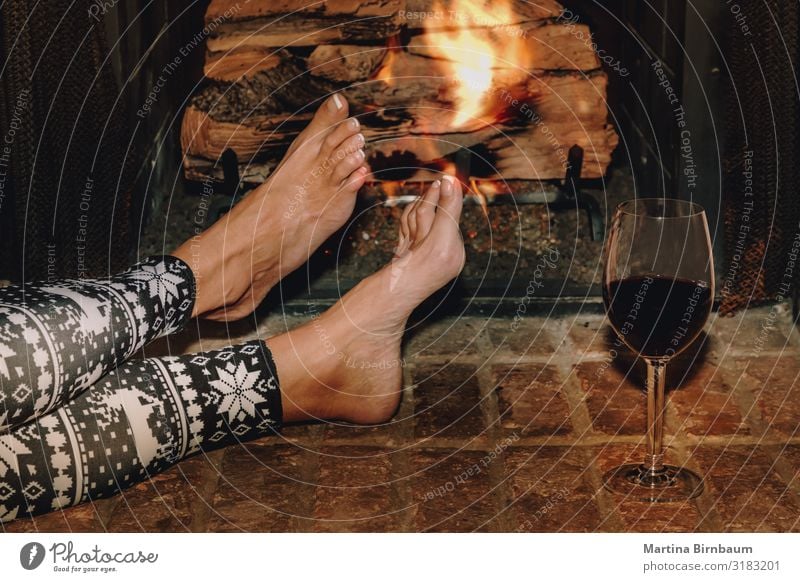 Woman resting with glass of red wine near fireplace Alcoholic drinks Lifestyle Relaxation Leisure and hobbies Winter House (Residential Structure)