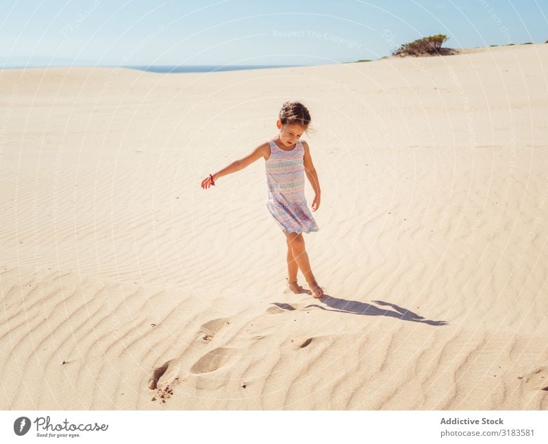 Cute Little Girl Playing With Sand At Beach A Royalty Free Stock Photo From Photocase