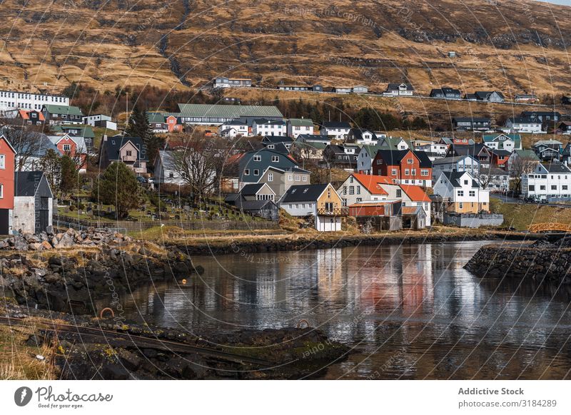 Small settlement near hill Town Hill Landscape House (Residential Structure) Føroyar Exterior Weather Sky Settlement Village cottages Rock Mountain Peak