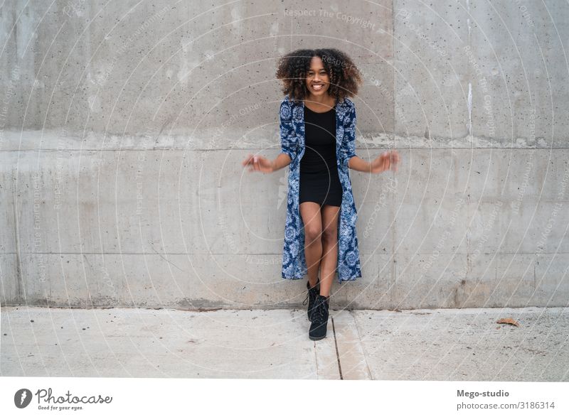 Afro-american woman against grey wall. Style Happy Beautiful Face Human being Woman Adults Fashion Clothing Brunette Smiling Stand Cool (slang) Friendliness
