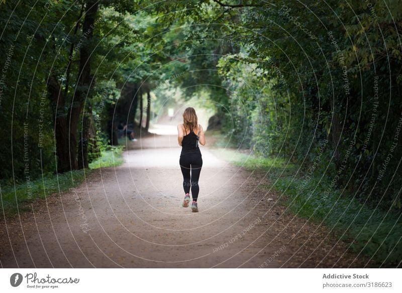 young fit woman running away doing sport on a path in park Woman Running Park Fitness Jogging Lifestyle Sports Healthy Youth (Young adults) pretty Human being