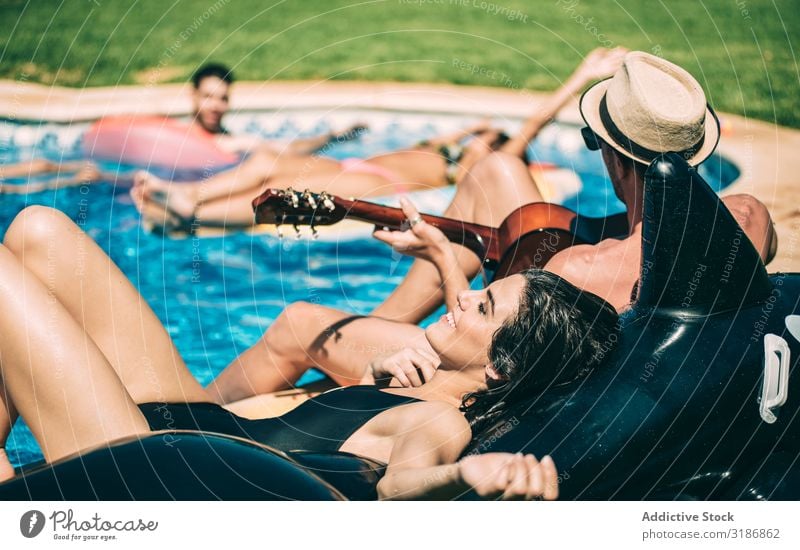 Men and women relaxing in poolside - a Royalty Free Stock Photo from  Photocase