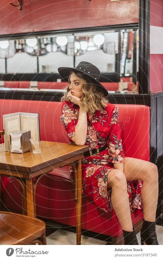 Elegant female sitting in cafe Woman Café Sit Couch Table To enjoy Youth (Young adults) Style outfit Dress Hat Hip & trendy Sofa Restaurant Lifestyle