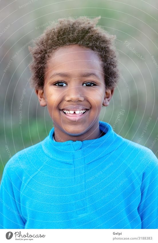 Happy african child with blue jersey Joy Relaxation Calm Leisure and hobbies Playing Child Boy (child) Infancy Autumn Park Meadow Afro Smiling Dream Happiness