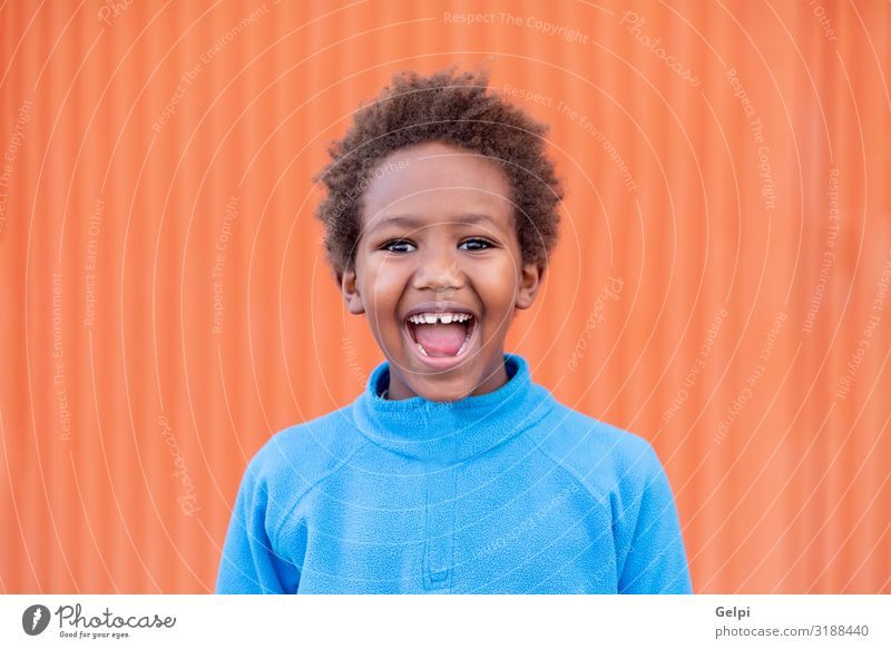 Funny african child with blue jersey Joy Relaxation Leisure and hobbies Playing Child Boy (child) Infancy Autumn Meadow Afro Smiling Dream Happiness Small Cute