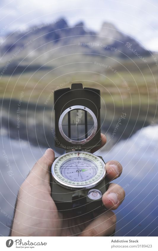 Crop hand with compass near lake Hand Compass (drafting) Lake Tourist embalse de casares Léon Spain Mountain Valley tranquil Trip Adventure Vacation & Travel