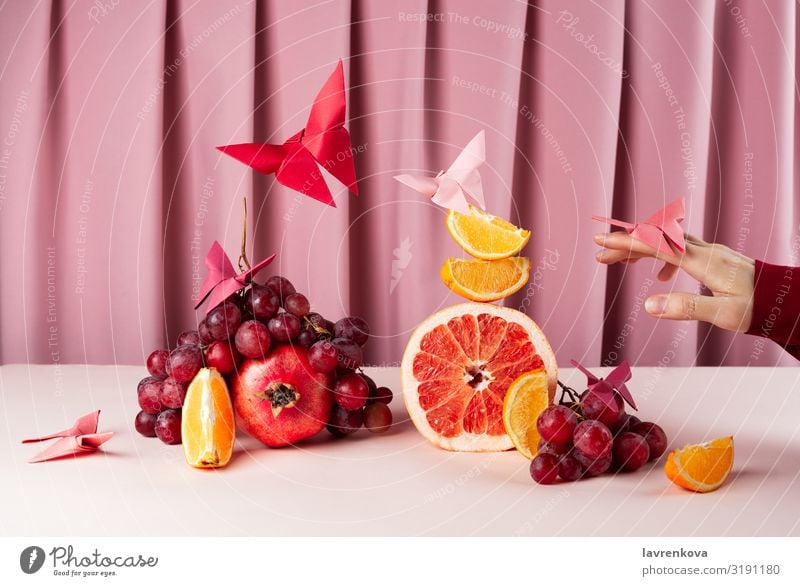 Various fruits on pink table with origame paper butterflies Breakfast Lemon Citrus fruits Diet Food Healthy Eating Food photograph Fresh Fruit Glass Grapefruit