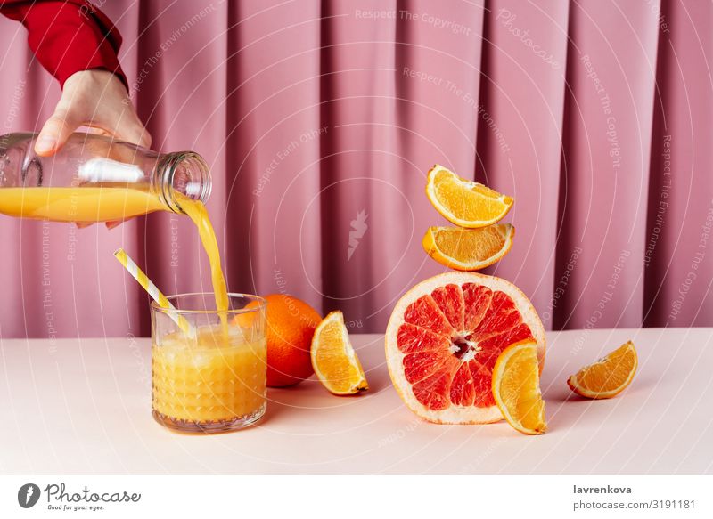 Woman pouring juice into the cup on the table with citrus fruits Beverage Breakfast Circus Lemon Citrus fruits Cocktail Diet Drinking Food Healthy Eating