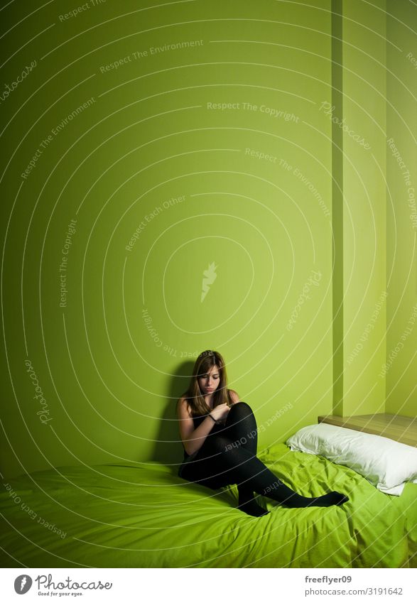 young woman alone on a green high ceiling room Woman Adults Youth (Young adults) Youth culture Sadness Small Green Emotions Pain Loneliness Shame Stress