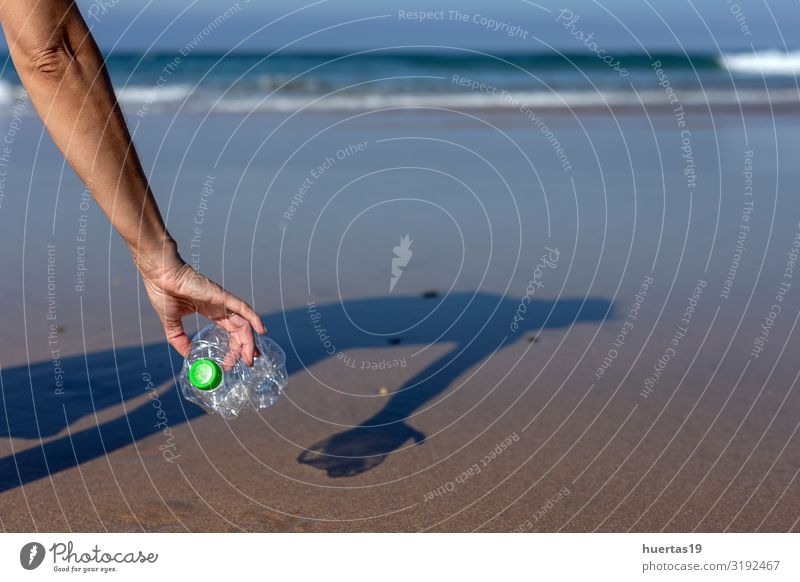 Woman picking up trash and plastics cleaning the beach Bottle Lifestyle Beach Ocean Human being Feminine Adults Hand 30 - 45 years Environment Nature Sand Coast