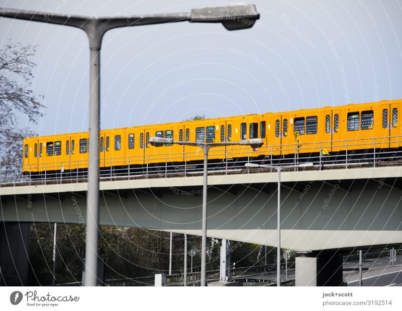 Subway runs regularly on the city highway Cloudless sky Winter Tegel Bridge Public transit City highway Rail transport Underground Driving Long Yellow Authentic