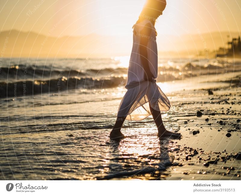 Adorable girl walking on seaside at sunset Girl Sunset Walking Delightful Coast Beach Summer Water Ocean Sunbeam Child Infancy Happy Happiness Vacation & Travel