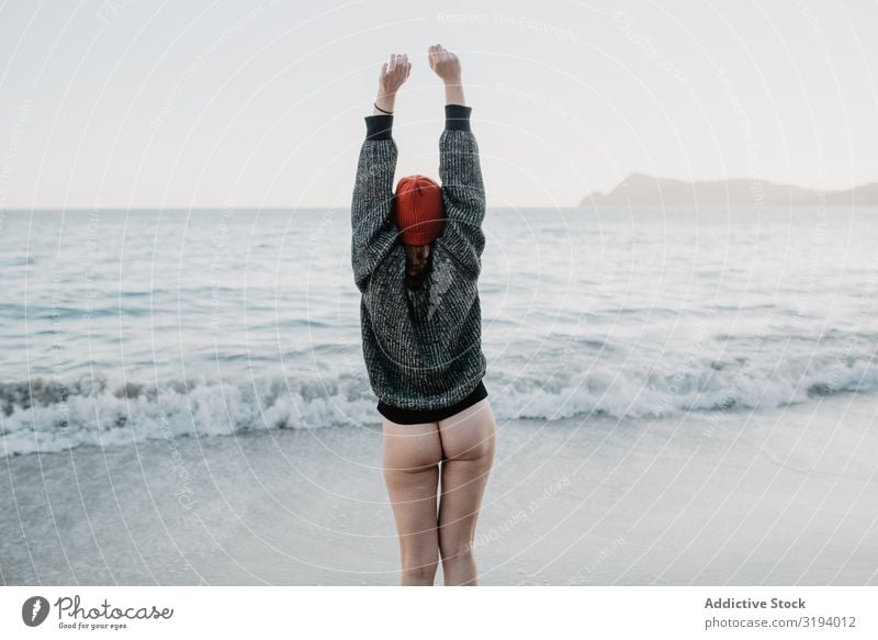 Unrecognizable woman enjoying freedom near waving sea Woman Ocean Freedom Waves Bottom raised Hands up! Storm Nature Water Naked Sweater Hat Beach Coast